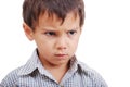 Very cute little boy with angry expression on face