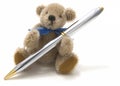 Very cute teddy bear holding a pen