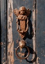 An amazing angel-shaped heavy iron door handle on a random house in Brugge, Belgium Royalty Free Stock Photo