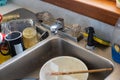 dirty dishes in old sink at vintage farmhouse