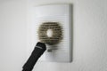 Very dirty and dusty white plastic ventilation grill. Ventilation shaft in the apartment. dirty air filter. Royalty Free Stock Photo