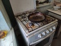 Very dirty and old gas stove and frying pan on the kitchen Royalty Free Stock Photo