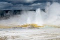 A very dramatic picture of geyser with dark storm clouds