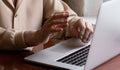 Very elderly woman happily holding a laptop