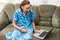 Very elderly woman holding a laptop