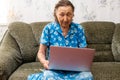 Very elderly woman holding a laptop