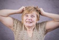 Very emotional angry woman with gold teeth on a gray background. Royalty Free Stock Photo