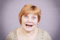 Very emotional woman with gold teeth on a gray background. Royalty Free Stock Photo