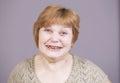 Very emotional woman with gold teeth smiling on a gray background. Royalty Free Stock Photo