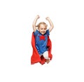 Very excited little girl dressed like hero jumping isolated on white background. Royalty Free Stock Photo