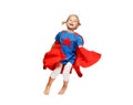 Very excited little girl dressed like hero jumping isolated on white background. Royalty Free Stock Photo