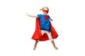 Very excited little girl dressed like superhero jumping isolated on white background. Royalty Free Stock Photo