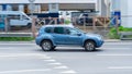 Very fast dangerous driving car on road. Blue Nissan Terrano (Dacia Duster) moves fast on the highway. Side view shot