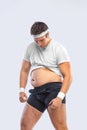 A funny fat man on white background. Obesity and eating disorder. Concept for dietetics and fitness advertising