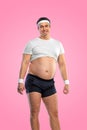 A funny fat man isolated on pink background. Obesity and eating disorder. Concept for dietetics and fitness advertising