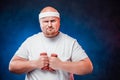 Very fat man with two dumbbells in each hand Royalty Free Stock Photo