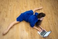 Very flexible woman exercising at home in front of her laptop, stretching her legs. Concept of individuality, creativity