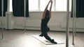 Very flexible woman stretching on an exercise mat during a workout