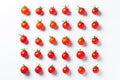 Very fresch tomatoes in symmetrical composition on white background, top view