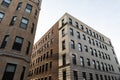 Very generic urban brick apartment buildings with rows of windows, urban cityscape