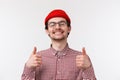 Very good. Close-up portrait satisfied handsome young man with moustache, wear red beanie and glasses, close eyes and Royalty Free Stock Photo