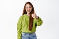 Very good. Smiling redhead teen shows thumbs up and looks satisfied, praise great deal, recommending store, make