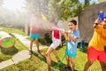Very happy boy with sprinkler in water gun fight Royalty Free Stock Photo
