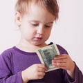 Very happy business baby girl with dollar banknote.