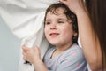 Cheerful kids and parents having pillow fight on bed at home Royalty Free Stock Photo