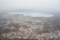 Very hazy, polluted aerial cityscape view from the Monsoon Palace of Udaipur, India Royalty Free Stock Photo