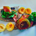 Healthy breakfast or brunch, favorite meal. selfbaked bread with olive cream,black zebra tomatoes and fresh apricots Royalty Free Stock Photo