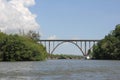 Very high arched bridge over a wide river