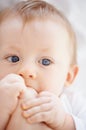 These are very interesting. Closeup shot of an adorable baby lying down and playing with its feet.