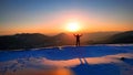 Very interesting moment. The young mountaineer managed to climb to the top and achieve his goal. Fantastic sunset. Royalty Free Stock Photo