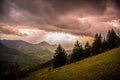 Very interesting sunset. View of spring landscapes, sunlight and dark clouds above. Royalty Free Stock Photo