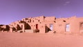 Very large adobe-style building in the middle of a desert setting