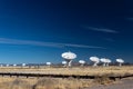 Very Large Array bright white radio antenna dishes against a deep blue sky, New Mexico desert in winter