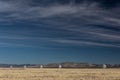 Very Large Array line of radio astronomy observatory telescopes in the New Mexico desert, copy space in blue sky