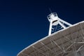 Very Large Array radio telescope pointing into space, white dish against a deep blue sky, space technology Royalty Free Stock Photo