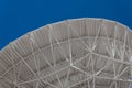 Very Large Array sweeping arch showing understructure of a large dish telescope against a blue sky, engineering and technology