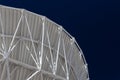 Very Large Array sweeping curve of a radio telescope antenna dish, white against a dark sky, science technology engineering Royalty Free Stock Photo
