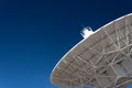 Very Large Array understructure of a radio telescope antenna dish pointing into a deep blue sky