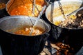 Very large cauldron cooking food during campfire. Cooking in a pot on the fire. Camping concept