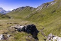 Very large and majestic alpine landscape in the Lord of the Rings style. In the foreground are some rocks, in the Royalty Free Stock Photo