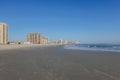 Very large wet sandy beach by the ocean with high rise condominium buildings in the background Royalty Free Stock Photo