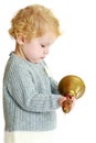 Very little girl sees big copper bell , close-up