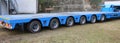 very long blue truck with six axles of wheels Royalty Free Stock Photo