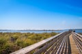 A very long boardwalk surrounded by shrubs in Gulf Shores, Alabama Royalty Free Stock Photo