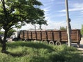 very long truck near wood and grass against the sky Royalty Free Stock Photo