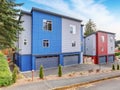 Very modernized apartment with red and blue colors with garage and driveway. Royalty Free Stock Photo